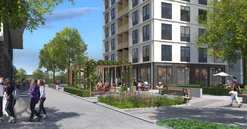 Visionsbild som visar en vit fastighet med café i bottenplan.